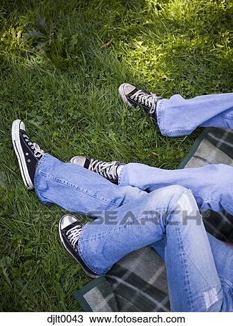 Young couple laying outdoors View Large Photo Image Stock Image - Young couple laying outdoors. Fotosearch