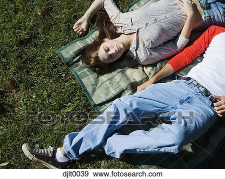 Young couple laying outdoors View Large Photo Image Stock Photo - Young couple laying outdoors. Fotosearch