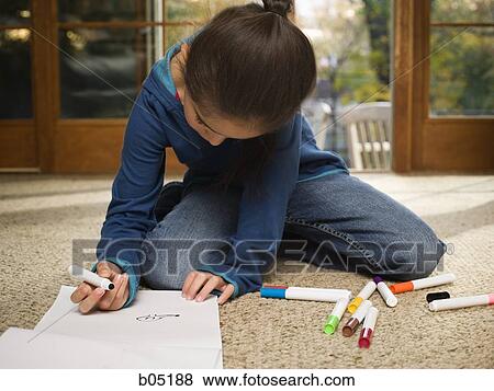 Stock Photo - Young girl coloring with markers. Fotosearch