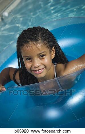 Young girl in in floatation tube in water View Large Photo Image Stock Image - Young girl in in floatation tube in water. Fotosearch