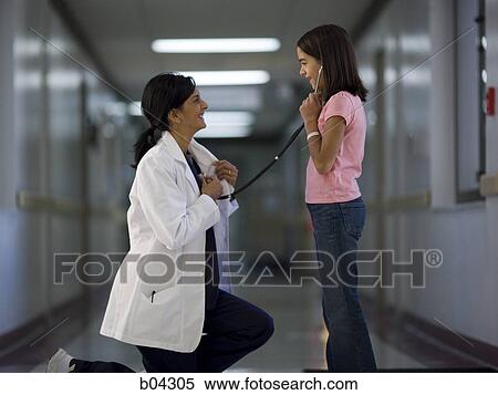 Young girl playing with female doctor's stethoscope View Large Photo Image Stock Photography - Young girl playing with female doctor's stethoscope. Fotosearch