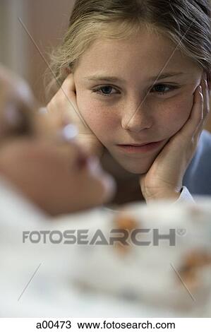 Young girl sitting by hospital bed View Large Photo Image Stock Image - Young girl sitting by hospital bed. Fotosearch