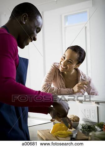A couple preparing food View Large Photo Image Stock Image - A couple preparing food. Fotosearch