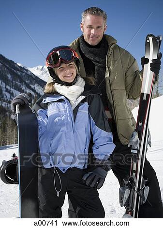 Stock Image - A father and his daughter outside in the snow. Fotosearch