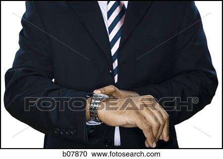African-American businessman checking his wristwatch View Large Photo Image Stock Image - African-American businessman checking his wristwatch. Fotosearch