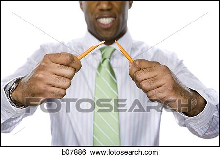 Stock Photograph - African-American businessman snapping a pencil in half. Fotosearch