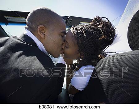 Stock Image - African-American newlywed couple in convertible car. Fotosearch