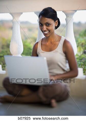 African-American woman sitting on balcony with laptop View Large Photo Image Stock Photography - African-American woman sitting on balcony with laptop. Fotosearch