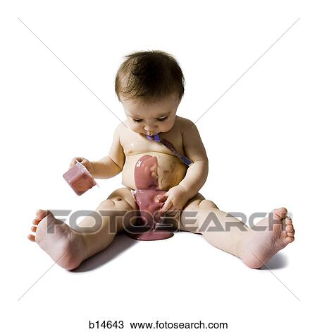 Stock Image - Baby eating birthday cake. Fotosearch