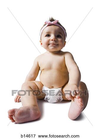 Baby girl sitting in diaper View Large Photo Image Stock Photo - Baby girl sitting in diaper. Fotosearch