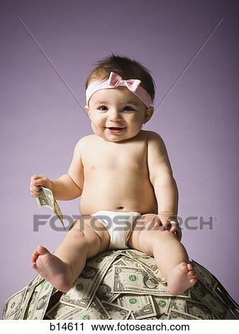 Baby girl sitting on pile of US currency View Large Photo Image Stock Image - Baby girl sitting on pile of US currency. Fotosearch