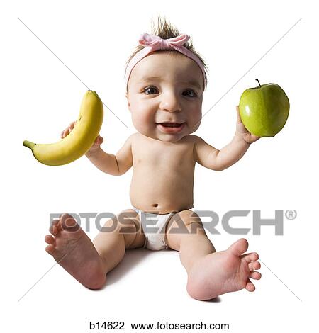 Baby girl with green apple and banana View Large Photo Image Stock Image - Baby girl with green apple and banana. Fotosearch