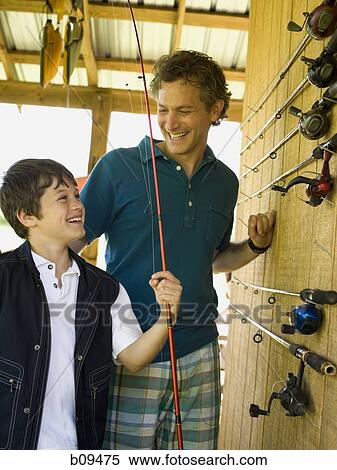 Stock Photography - Boy and a man standing in a store. Fotosearch