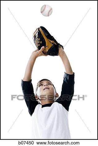 Stock Image - Boy catching a baseball in glove. Fotosearch