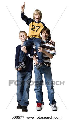 Boy hoisted on shoulders making hand gesture View Large Photo Image Stock Photo - Boy hoisted on shoulders making hand gesture. Fotosearch