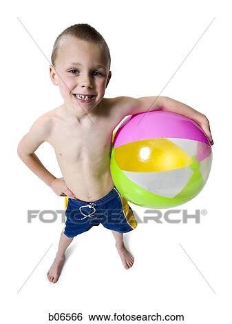 Boy holding beach ball View Large Photo Image Stock Photograph - Boy holding beach ball. Fotosearch