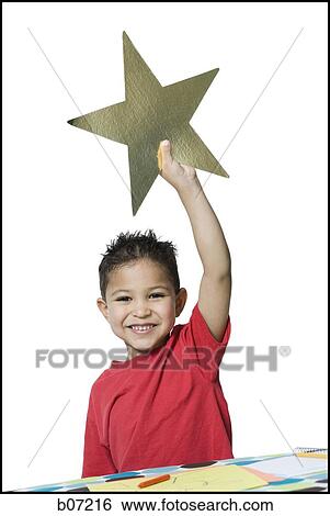 Boy holding up star View Large Photo Image Stock Photograph - Boy holding up star. Fotosearch