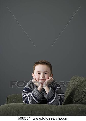 Boy on couch View Large Photo Image Picture - Boy on couch. Fotosearch