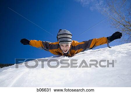 Boy sliding on stomach View Large Photo Image Stock Image - Boy sliding on stomach. Fotosearch