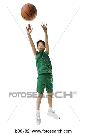 Boy throwing a basketball View Large Photo Image Stock Image - Boy throwing a basketball. Fotosearch