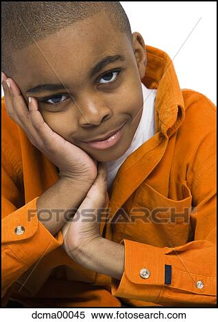 Stock Photography - Boy with head in hand. Fotosearch
