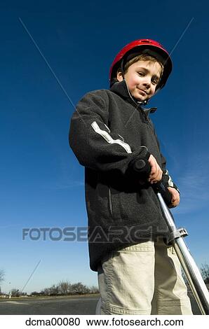 Boy with helmet and scooter View Large Photo Image Stock Image - Boy with helmet and scooter. Fotosearch