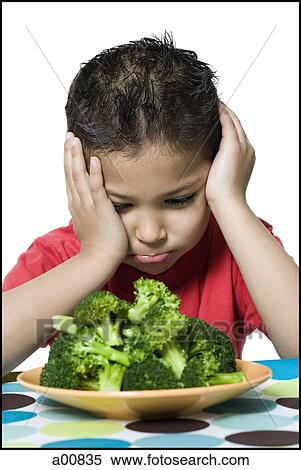 Boy with plate of broccoli frowning View Large Photo Image Stock Photography - Boy with plate of broccoli frowning. Fotosearch