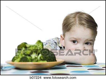 Picture - Boy with plate of broccoli. Fotosearch