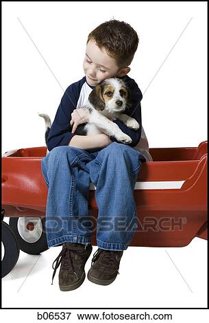 Boy with puppy and toy wagon View Large Photo Image Stock Photo - Boy with puppy and toy wagon. Fotosearch