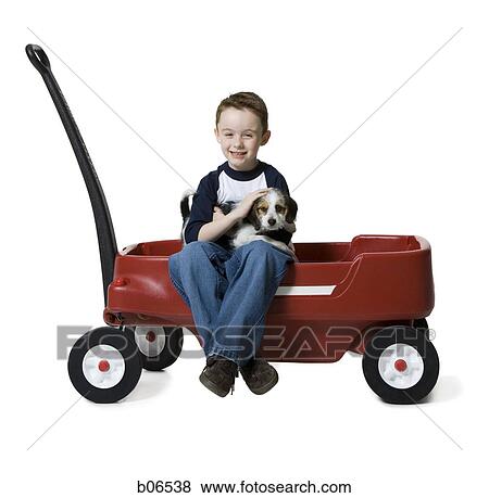 Boy with puppy and toy wagon View Large Photo Image Stock Photo - Boy with puppy and toy wagon. Fotosearch