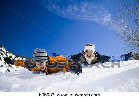 Brother and sister sliding on stomachs View Large Photo Image Stock Image - Brother and sister sliding on stomachs. Fotosearch