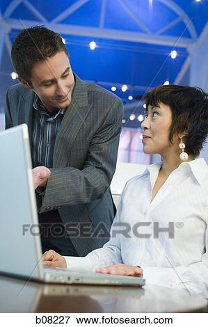 Businessman and a businesswoman talking View Large Photo Image Stock Photo - Businessman and a businesswoman talking. Fotosearch