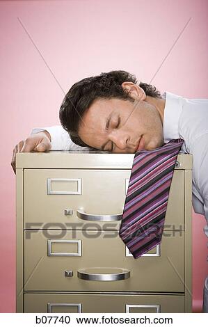 Businessman falling asleep on file cabinet View Large Photo Image Stock Image - Businessman falling asleep on file cabinet. Fotosearch