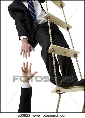 Businessman helping someone up ladder View Large Photo Image Stock Image - Businessman helping someone up ladder. Fotosearch
