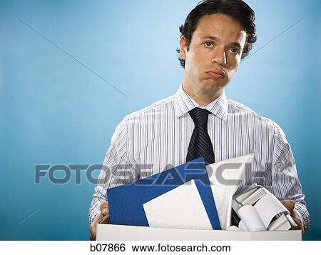 Businessman holding box of office property View Large Photo Image Stock Photograph - Businessman holding box of office property. Fotosearch