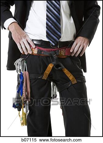 Businessman wearing rock climbing belt View Large Photo Image Stock Photography - Businessman wearing rock climbing belt. Fotosearch