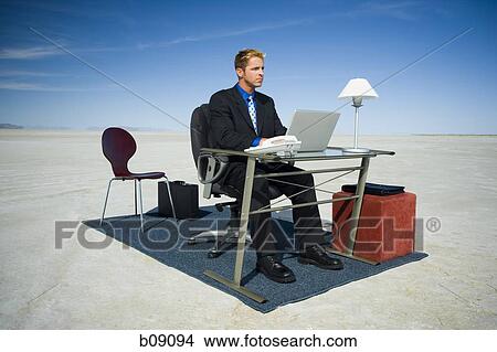 Picture - Businessman working on a laptop. Fotosearch