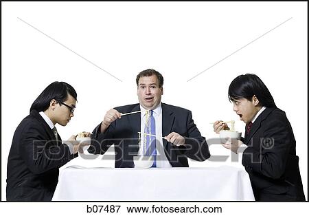 Stock Photo - Businessmen eating noodles. Fotosearch