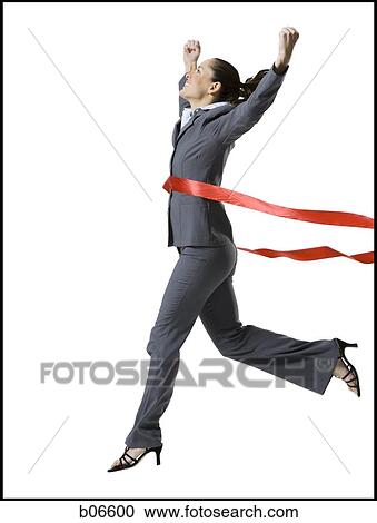 Stock Image - Businesswoman crossing finish line. Fotosearch