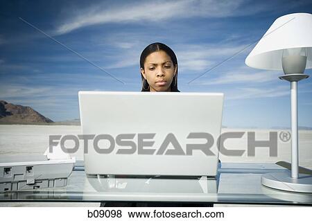 Stock Photo - Businesswoman working on a laptop. Fotosearch