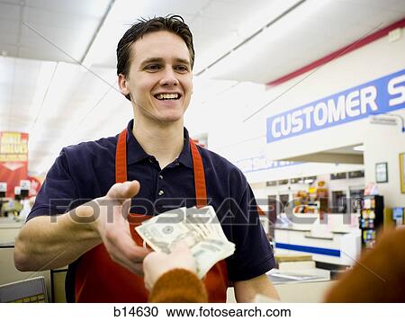 Cashier taking money from customer View Large Photo Image Stock Image - Cashier taking money from customer. Fotosearch