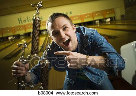Champion bowler showing off trophy View Large Photo Image Picture - Champion bowler showing off trophy. Fotosearch
