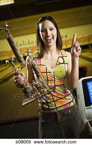Champion bowler showing off trophy View Large Photo Image Stock Photography - Champion bowler showing off trophy. Fotosearch