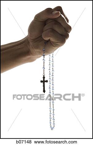Clenched fist holding rosary beads View Large Photo Image Stock Photo - Clenched fist holding rosary beads. Fotosearch