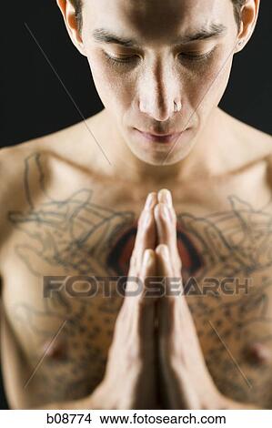 Close-up of a bare chested young man with head bowed View Large Photo Image Picture - Close-up of a bare chested young man with head bowed. Fotosearch
