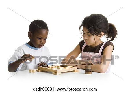 Close-up of a boy and a girl playing a board game View Large Photo Image Stock Image - Close-up of a boy and a girl playing a board game. Fotosearch