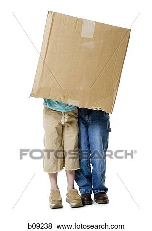 Close-up of a boy and a girl wearing a cardboard box View Large Photo Image Stock Photo - Close-up of a boy and a girl wearing a cardboard box. Fotosearch