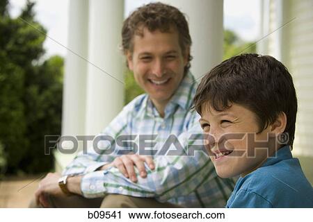 Close-up of a boy and his father smiling View Large Photo Image Stock Image - Close-up of a boy and his father smiling. Fotosearch
