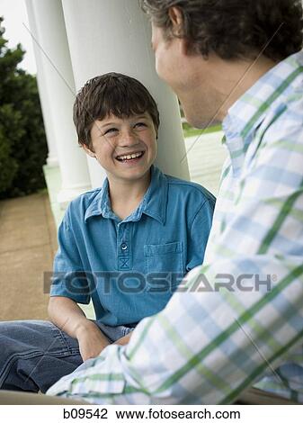 Close-up of a boy and his father smiling View Large Photo Image Stock Image - Close-up of a boy and his father smiling. Fotosearch