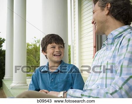 Stock Image - Close-up of a boy and his father smiling. Fotosearch